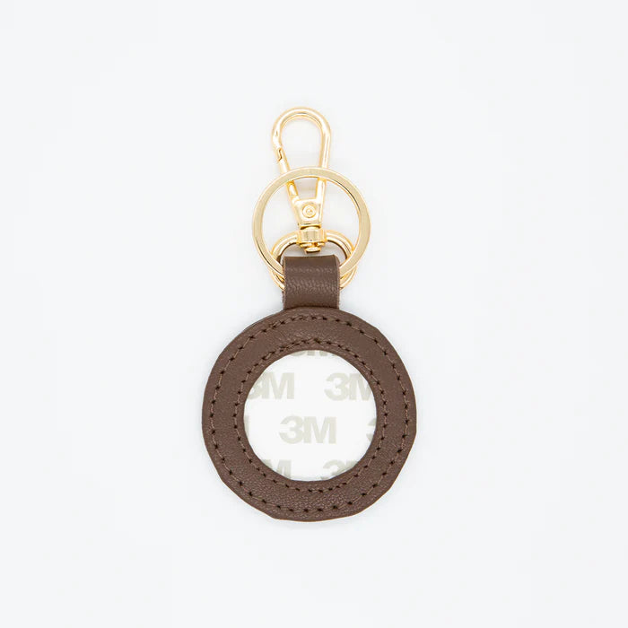 Brown keychain with gold ring on a white background
