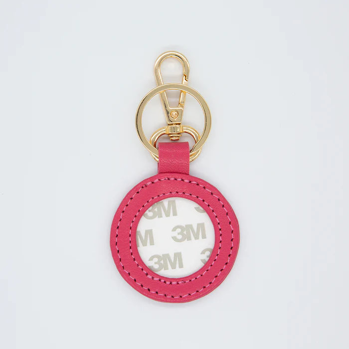 Pink keychain with gold ring on a white background