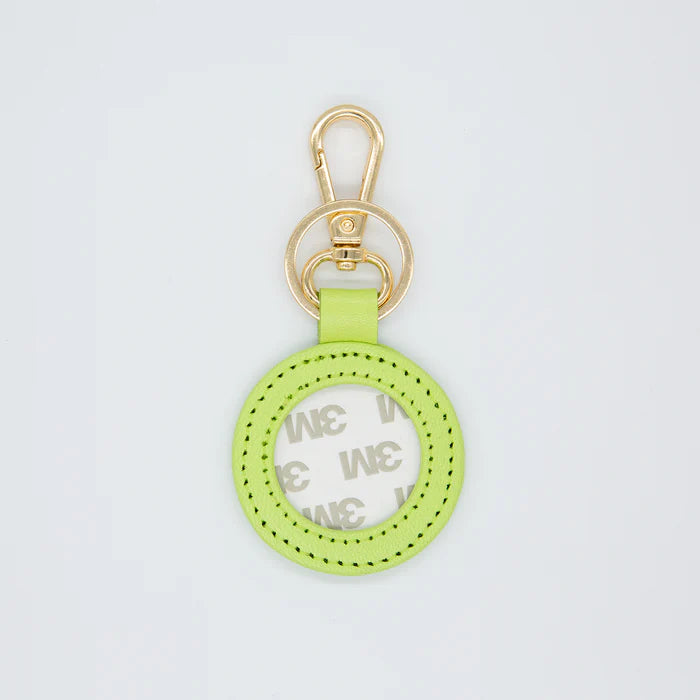 Green keychain with gold clasp on a light gray background