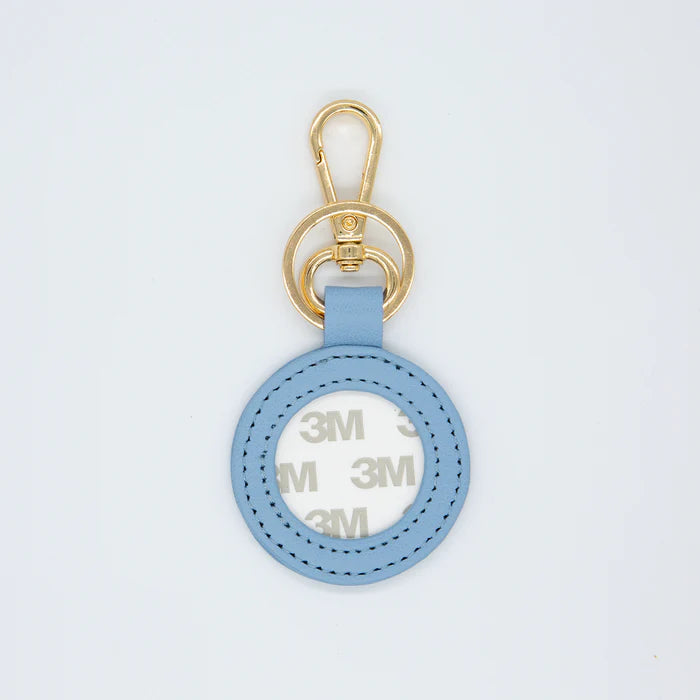 Blue keychain with gold clasp on a light gray background