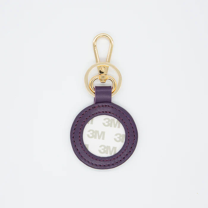 Purple keychain with gold clasp on a white background