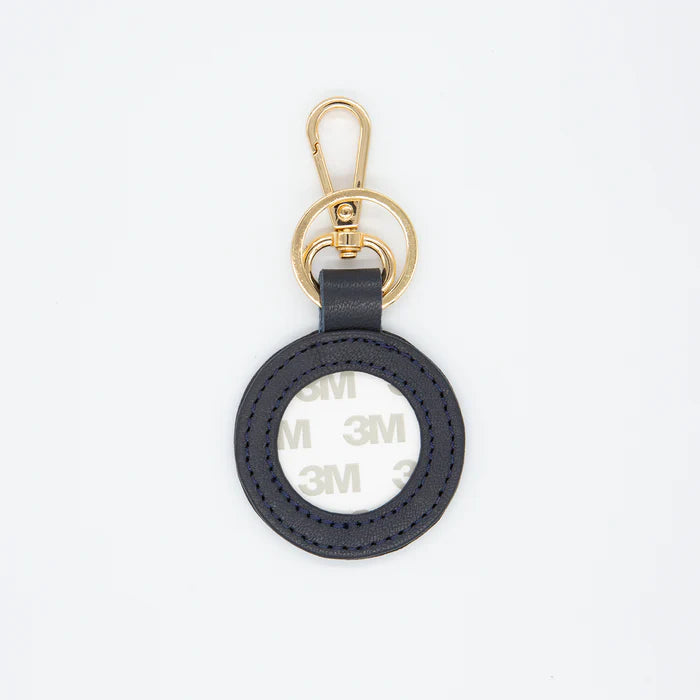Black keychain with gold clasp on a white background