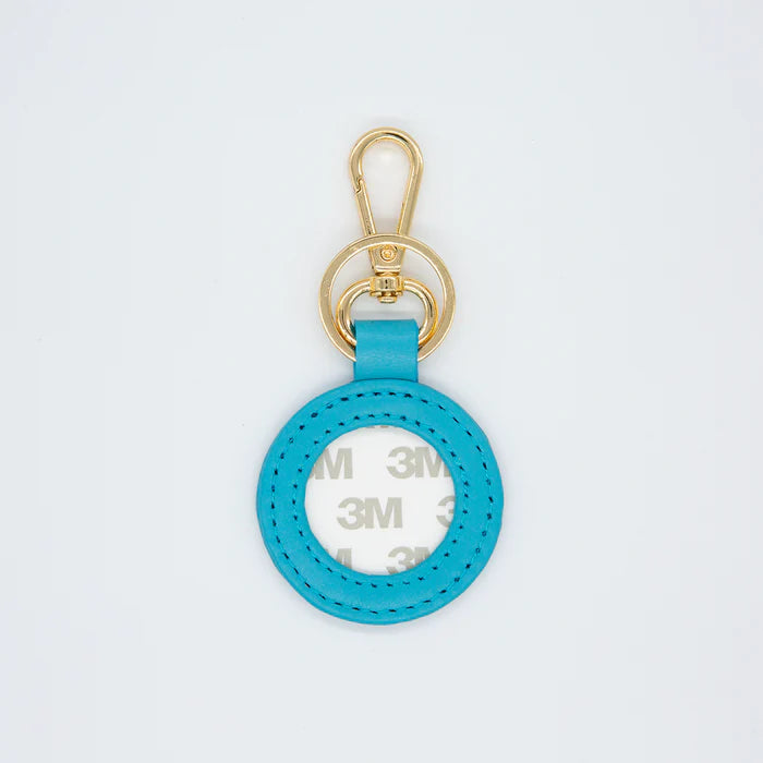 Blue keychain with gold clasp on a light gray background