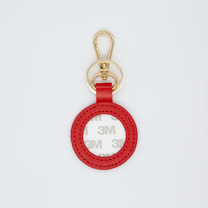 Red keychain with gold clasp on a white background